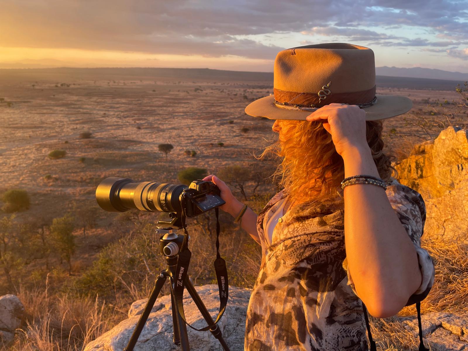 Roberta Marroquín photographing at golden hour above the Tanzanian savanna